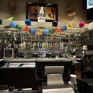 a bar with many bottles of alcohol