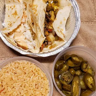 Grilled fish taco , veggie taco , side of rice and jalapeno slices .