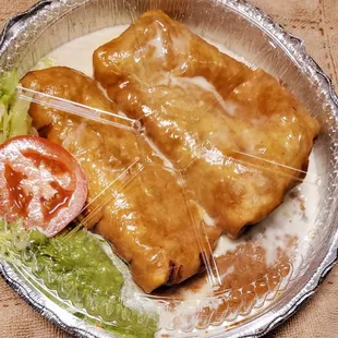 Beef chimichangas , chicken chimichangas, beans and guacamole salad.