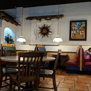 a dining area with a table and chairs