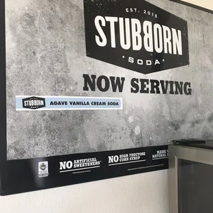 a tv and a sign on a wall