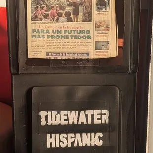 This is the Tidewater Hispanic Magazine Rack outside the entrance of the restaurant.  Photo taken January 1, 2025.