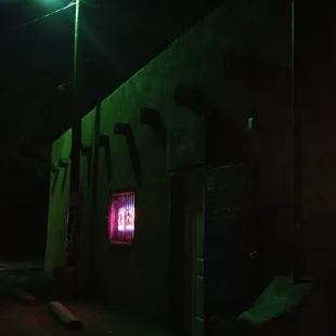a neon sign on the side of a building