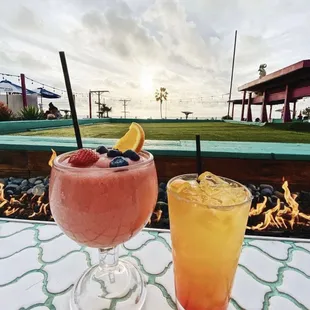 two drinks on a table outside