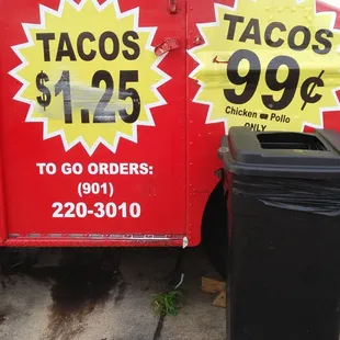 a taco truck and a trash can