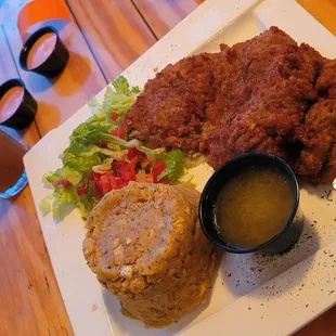 Tamarind drink with mofongo and breaded cubed steak with salad