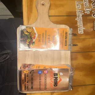 a cutting board with a menu on it