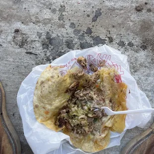 The barf of the carnitas burrito I was served. The drippings on the floor are grease. The bag is covering up 80% of the puddle