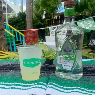 a bottle of horritos next to a shot glass