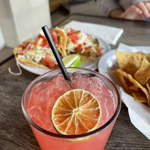 Strawberry margarita. Fish tacos in background.