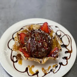 a dessert with chocolate sauce and strawberries