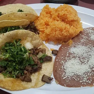 a plate of mexican food with rice and beans