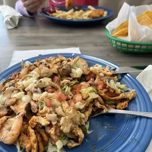 El Puente salad- grilled shrimp, chicken and mushrooms topped with cheese over lettuce, tomato &amp; pico de gallo. 1/4 already eaten.