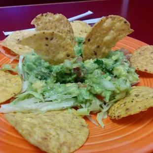 Partially eaten guacamole salad. Very tasty.