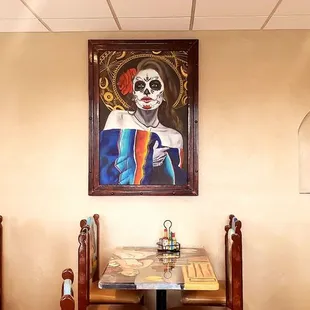 a painting of a mexican woman in a restaurant