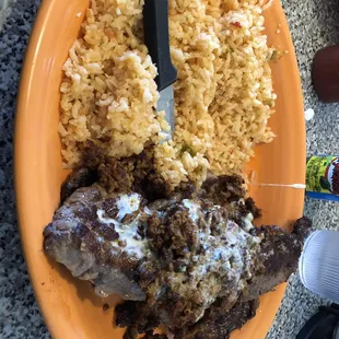 a plate of food with rice and meat