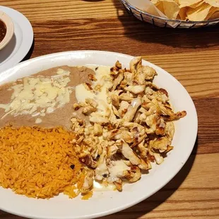 "Pollo Bandito" - Grilled chicken strips covered with queso, served with rice, beans, and corn or flour tortillas.