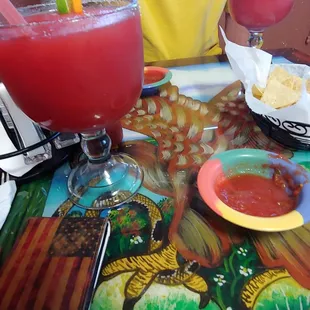 a man sitting at a table with drinks