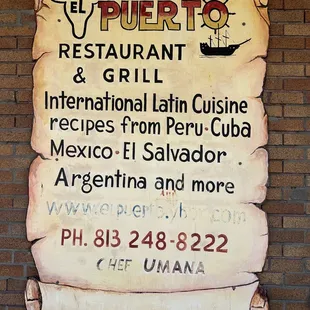 a sign on a brick wall