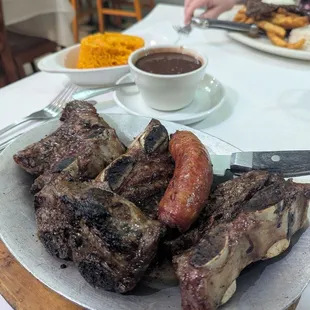 El Puerto Platter, beef short ribs and sausage with yellow rice &amp; black beans