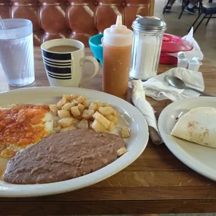 Huevos rancheros with a chorizo con huevo taco on the side.