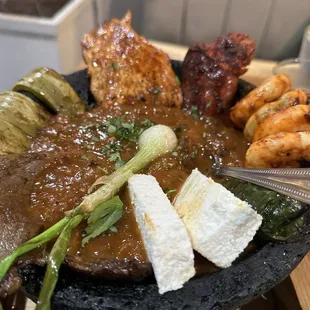 House specially! Grilled Steak, Chicken and shrimp, chorizo, grilled cactus and queso fresco served in a hot lava bowl with roasted salsa.