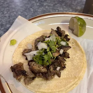 Carne asada tacos with steak. Fresh cilantro and onions. I had 2 and it was the perfect portion for me.