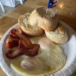 Breakfast plate with 2 fried eggs, the thickest &amp; yummiest bacon and freshly baked bread.