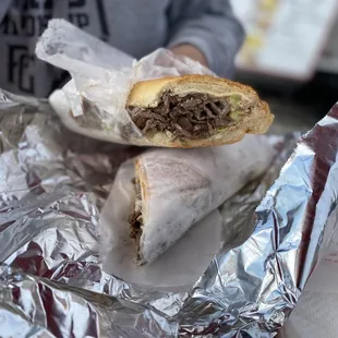 a person holding a sandwich