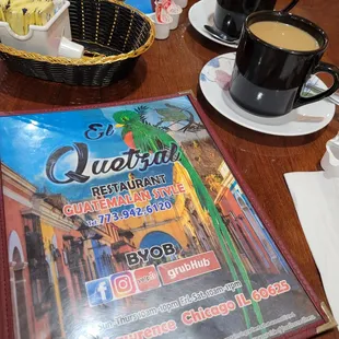 a table with coffee and a menu