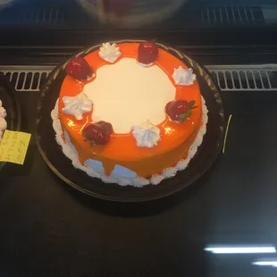 a cake with strawberries and whipped cream