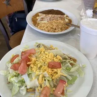 Closer view of el ragas plate. 2crispy tacos cheese tomato lettuce with the rice enchilada beans plate