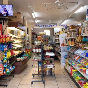 a grocery store with a television in the background