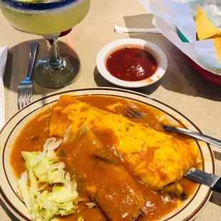 a plate of enchiladas and a drink