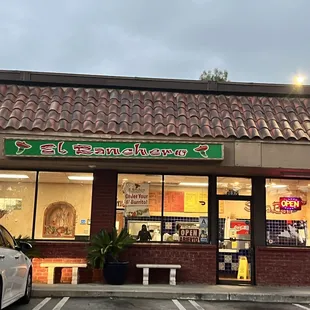 a car parked in front of a restaurant