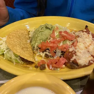 a plate of mexican food and a drink