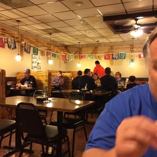 a man sitting at a table with a glass of wine