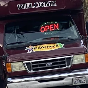 an open sign on the front of a truck