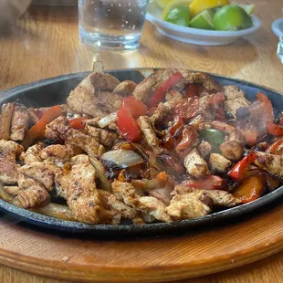 a skillet of chicken and peppers