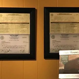 two framed certificates