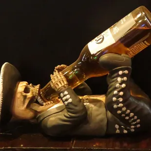 a statue of a man drinking a beer