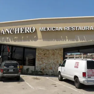 two vans parked in front of the restaurant