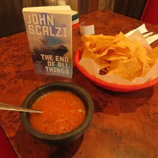 a bowl of tortilla and a book