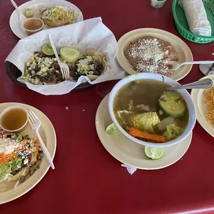 Gorditas, asada tacos and caldo de res with a side of beans and rice.