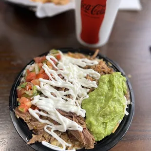 a plate of nachos and guacamole