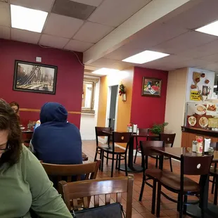 a woman sitting at a table in a restaurant