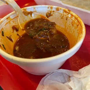 a bowl of chili with a spoon in it