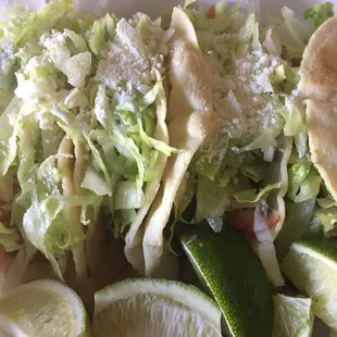 Supremo adds lettuce tomatoes cheese and crema to the basic cilantro and onions.