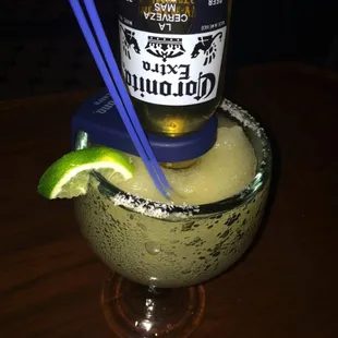 a margarita in a glass with chopsticks