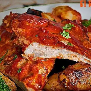a plate of ribs and potatoes